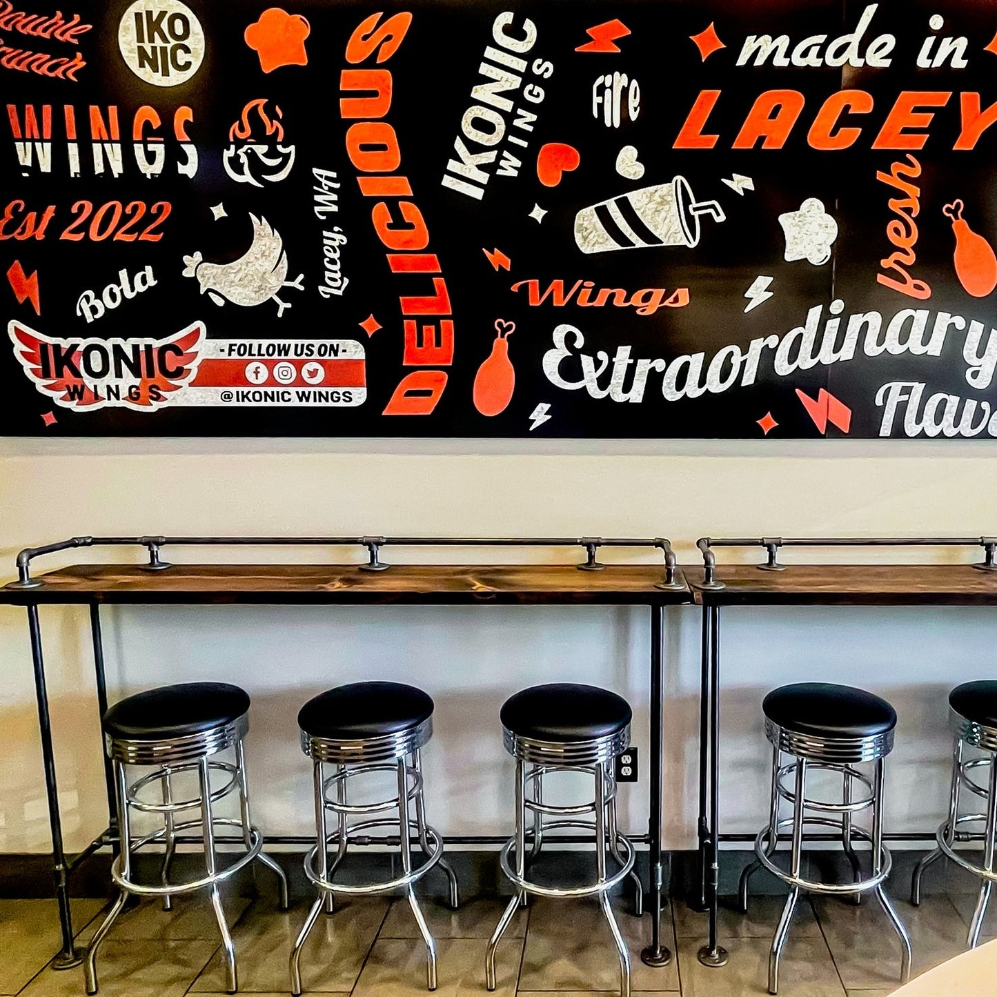 Handmade industrial bar tables with drink rail, Restaurant cafe diner signage, bar stools and foot rest.