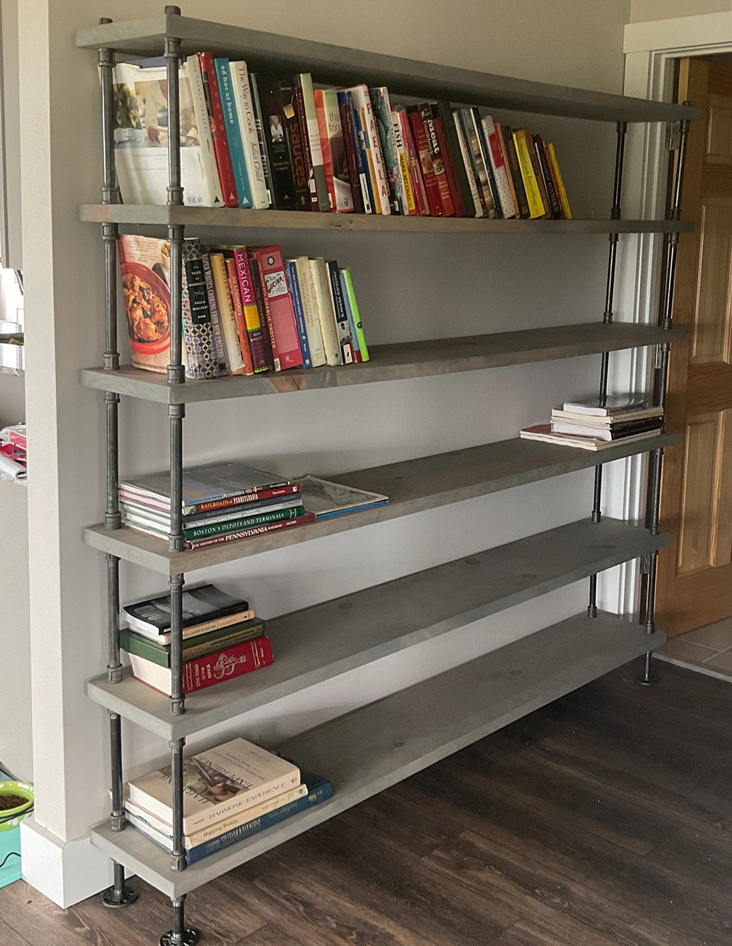 Handmade bookshelves unit with industrial black iron steel pipes and pine wood sanded smooth, stained in cool toned gray finish. Shelving unit is 72 inches wide with 6 shelves tall for ample storage for books, office workbooks, equipment for pantry or food storage.