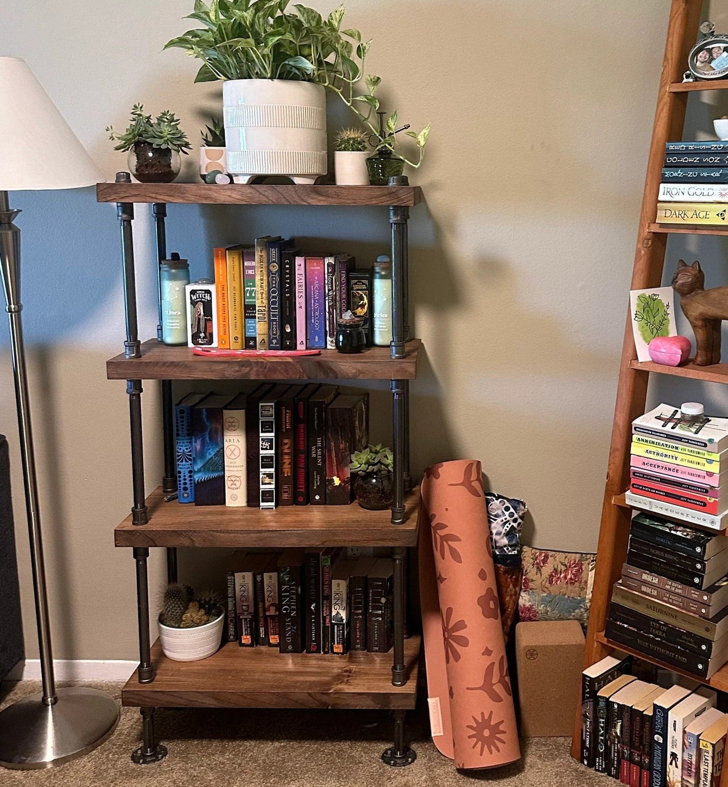 Wooden bookshelf with books and decorative items in a room setting