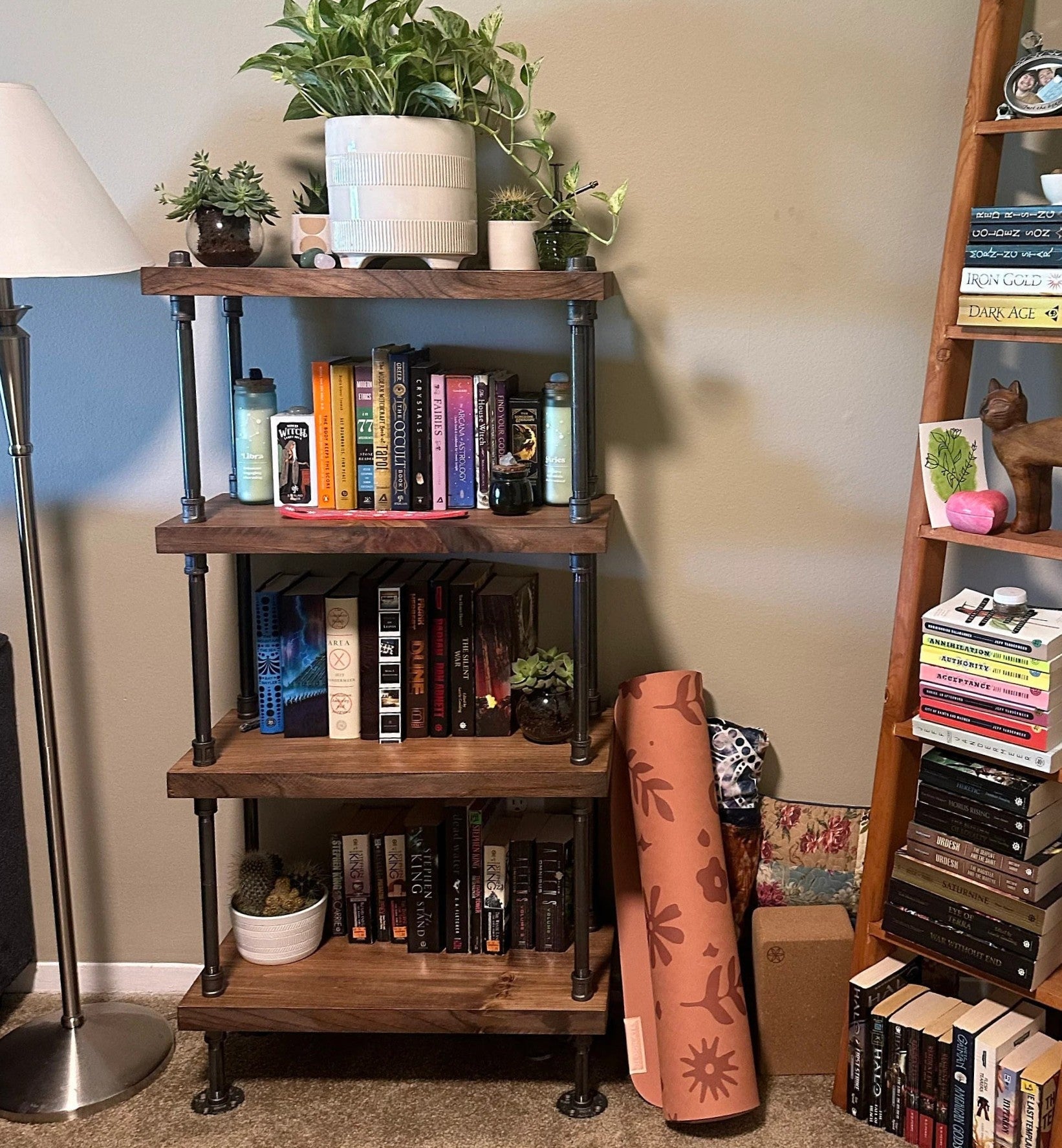 Wooden bookshelf with books and decorative items in a room setting