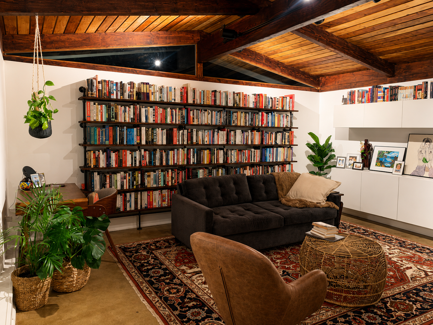 Cozy living room with bookshelves, sofa, and armchair.